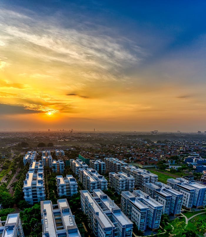 A stunning aerial shot of a Banten, Indonesia residential area under a vibrant sunset sky.